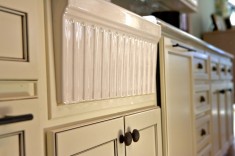 The glazed kitchen cabinets evoke a cottage-chic style.